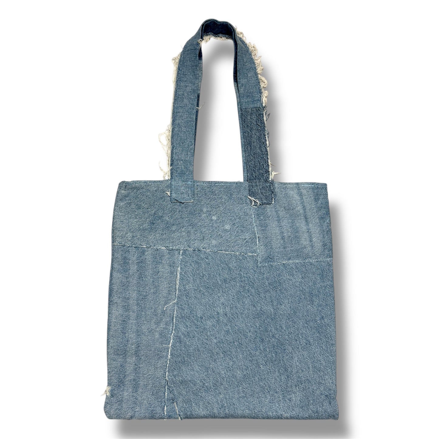 Back side of Iconic Green tote bag made from light and dark recycled denim pieces with clean patchwork lines.