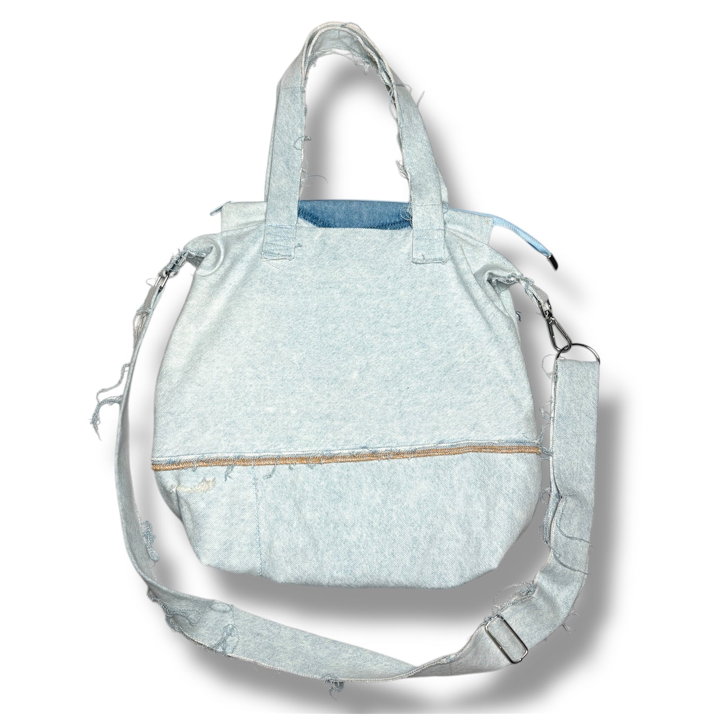 Back of IVENUSA light-wash upcycled tote bag with raw hem stitching and wide shoulder strap.