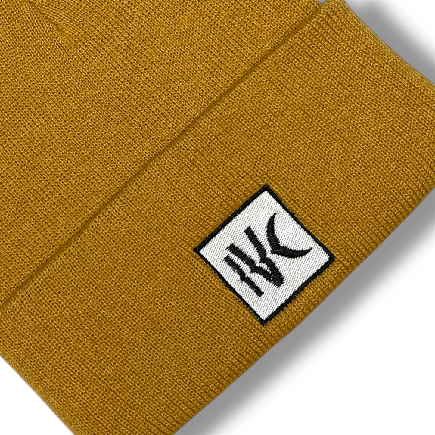 IVENUSA mustard yellow knit beanie with fold-over cuff and centered IVC brand patch, urban winter accessory.