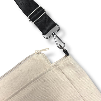 Close-up view of the adjustable black strap and beige zipper attachment of the Rush Hour Bag from IVENUSA Design, showing the canvas texture and secure hardware.