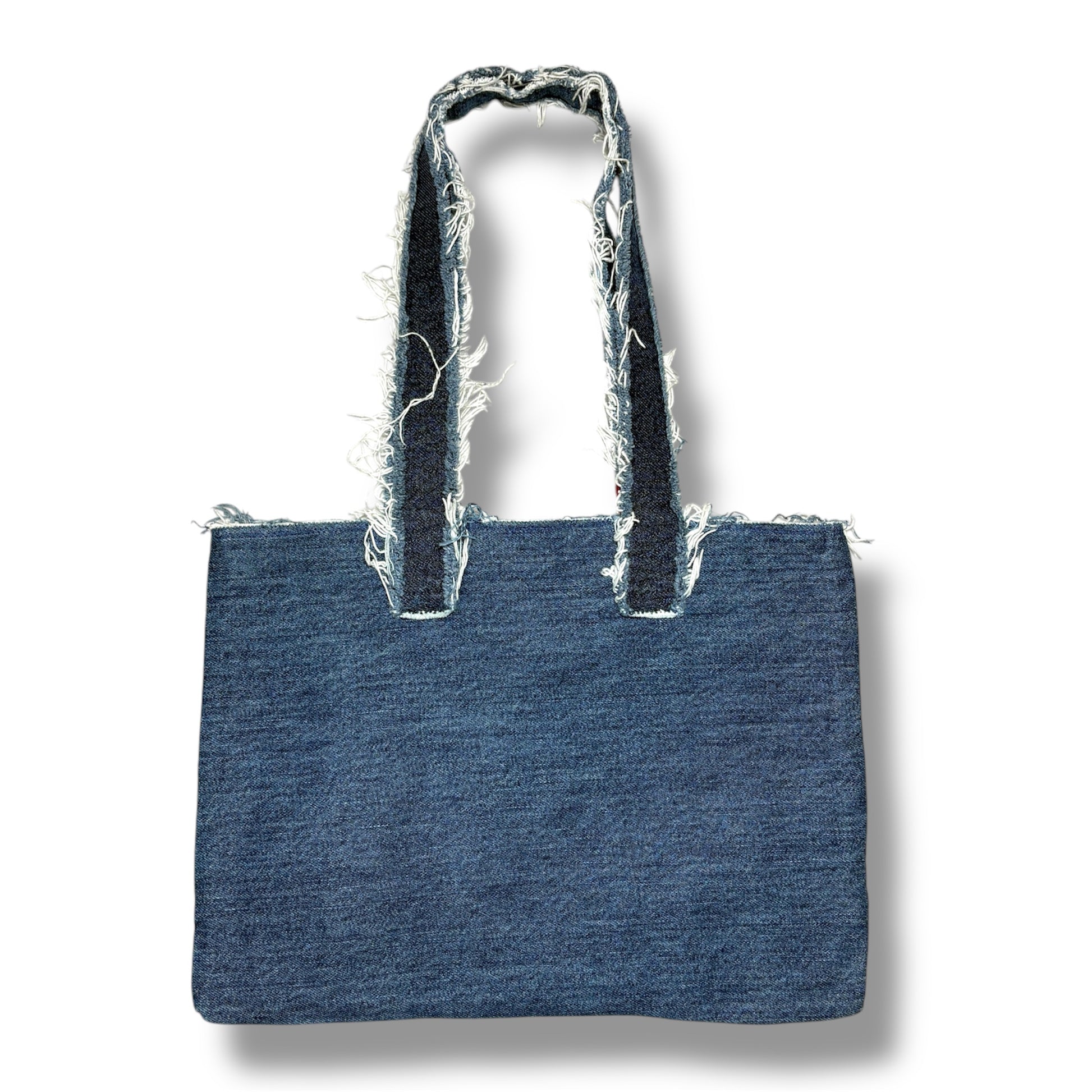 Back view of the Denim Pink Handbag with frayed denim handles and a clean blue denim patchwork panel.