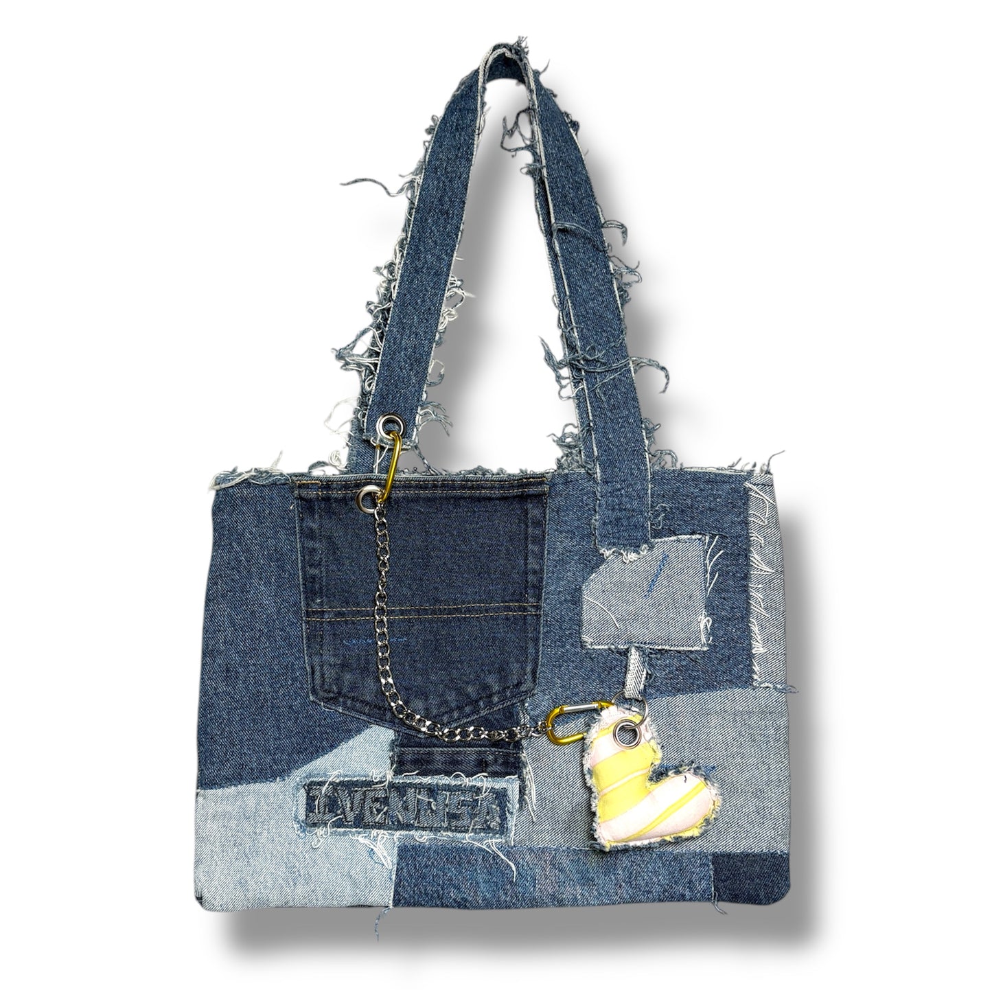 Front view of the Denim Yellow Handbag featuring patchwork denim, frayed handles, a front pocket, and a yellow heart charm