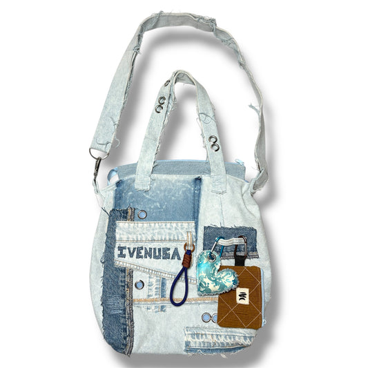 IVENUSA light-wash upcycled denim tote bag with mixed patchwork panels, grommet details, and handcrafted keychain accessories.
