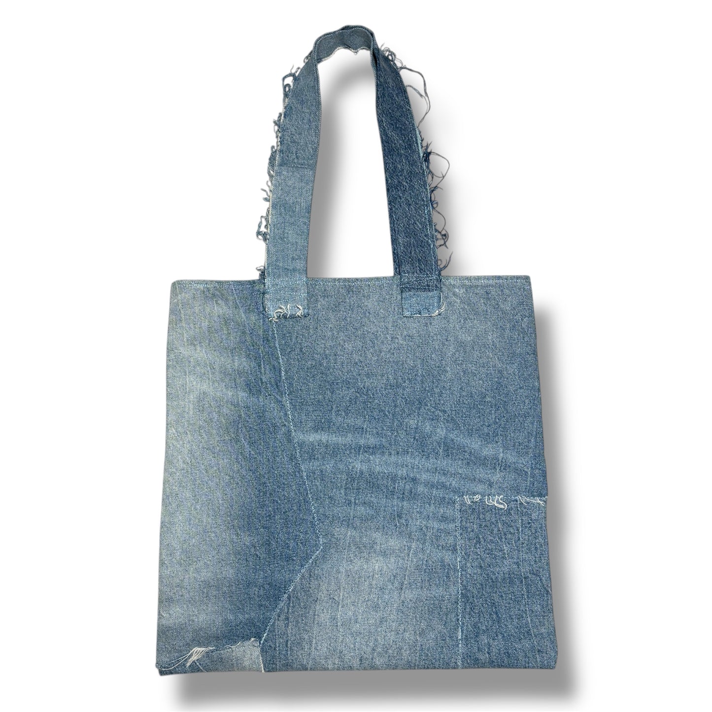 Backside of the Iconic Yellow denim tote showing a clean light-wash patchwork panel and sturdy handles.