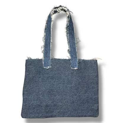 Back view of the Denim Orange Handbag in dark wash denim with frayed strap edges.
