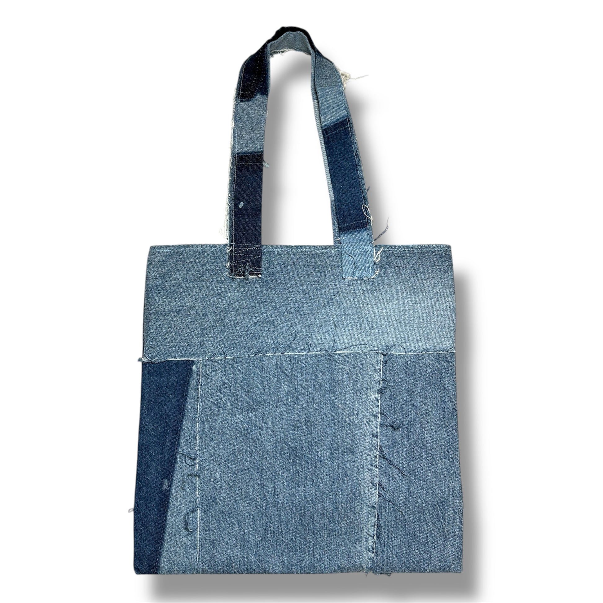 Backside of handmade denim tote bag featuring boho-style patches
