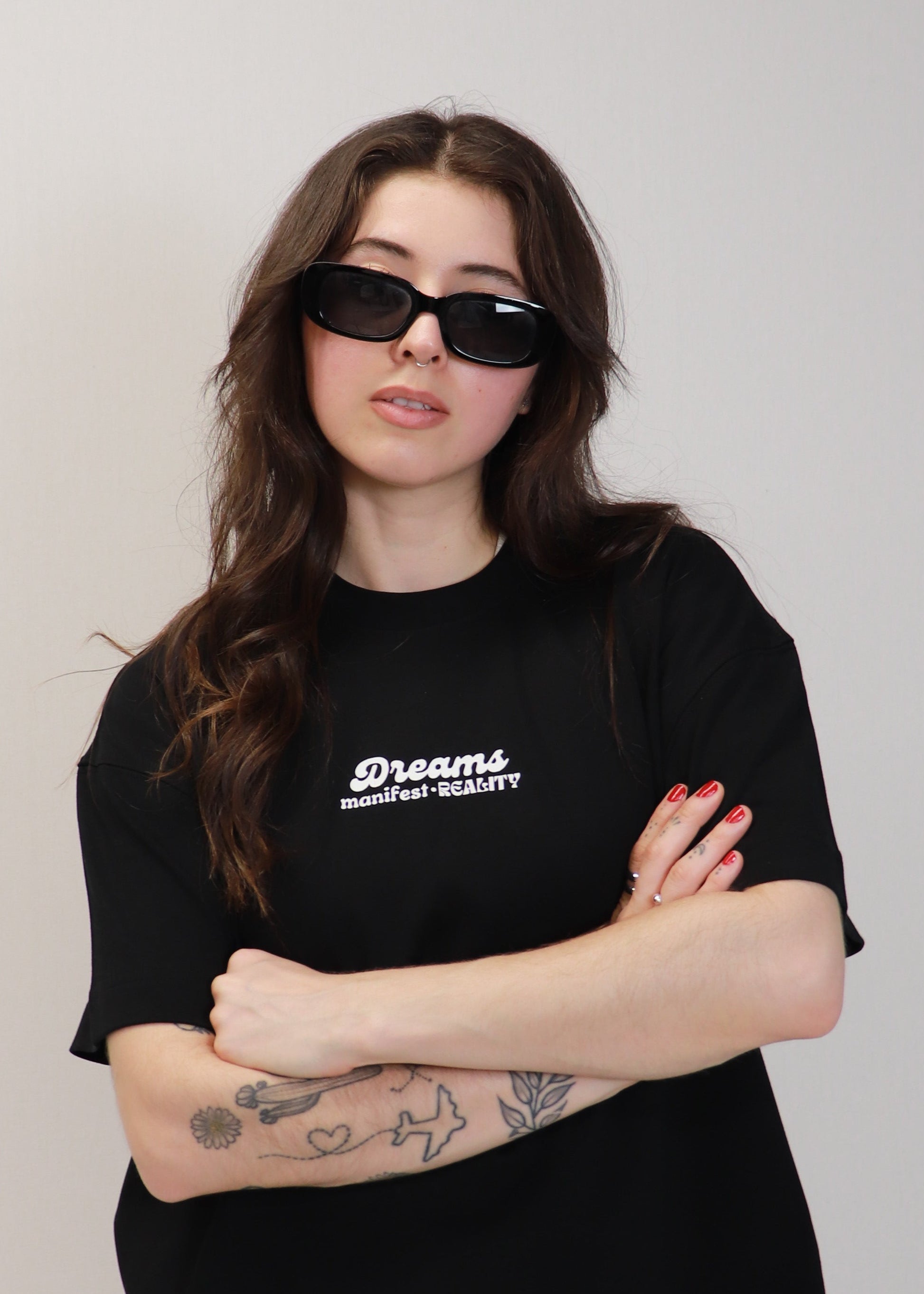 Close front view of black DMR oversized t-shirt worn by female model