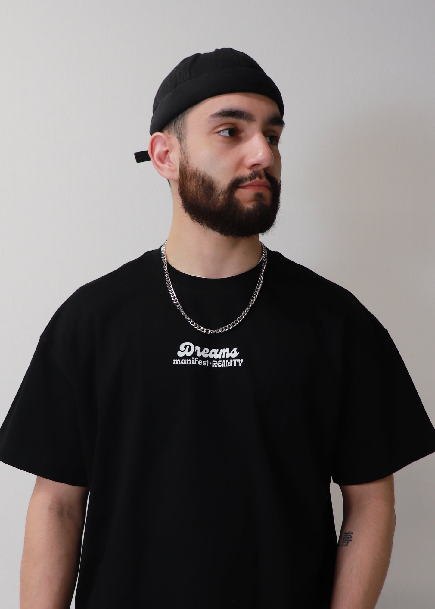 Minimal front view of black DMR oversized boxy t-shirt