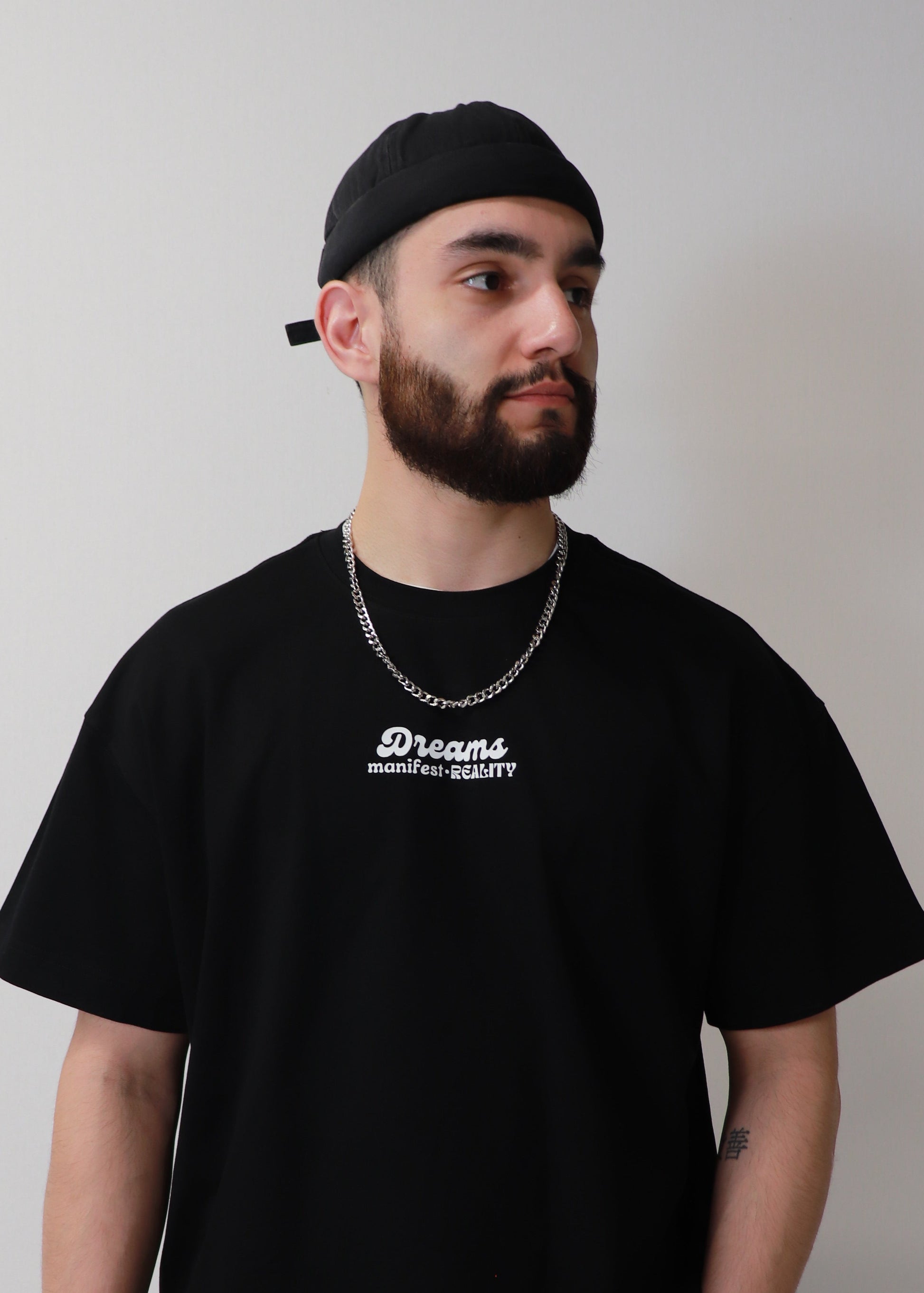 Minimal front view of black DMR oversized boxy t-shirt