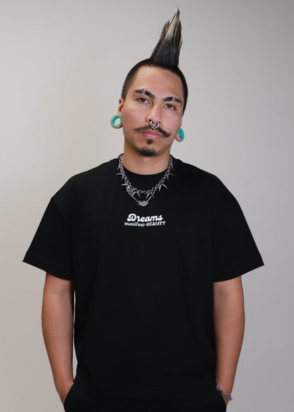 Male model wearing black DMR oversized boxy t-shirt front view