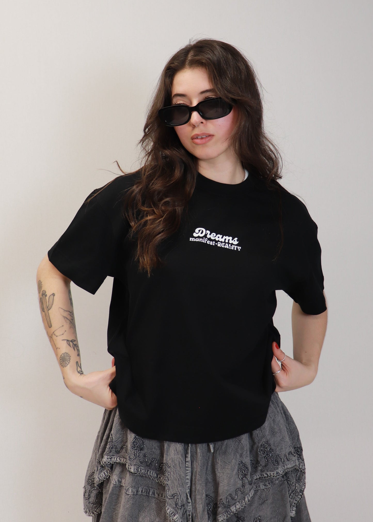 Female model wearing black DMR oversized boxy t-shirt with sunglasses
