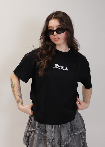 Female model wearing black DMR oversized boxy t-shirt with sunglasses