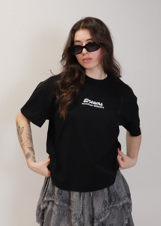 Female model wearing black DMR oversized boxy t-shirt with sunglasses