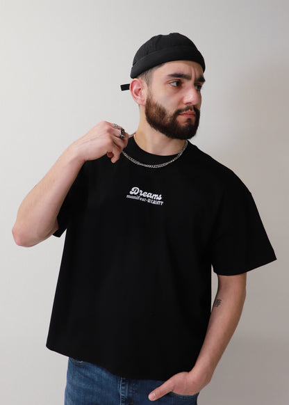 Side view of black DMR oversized t-shirt worn by male model