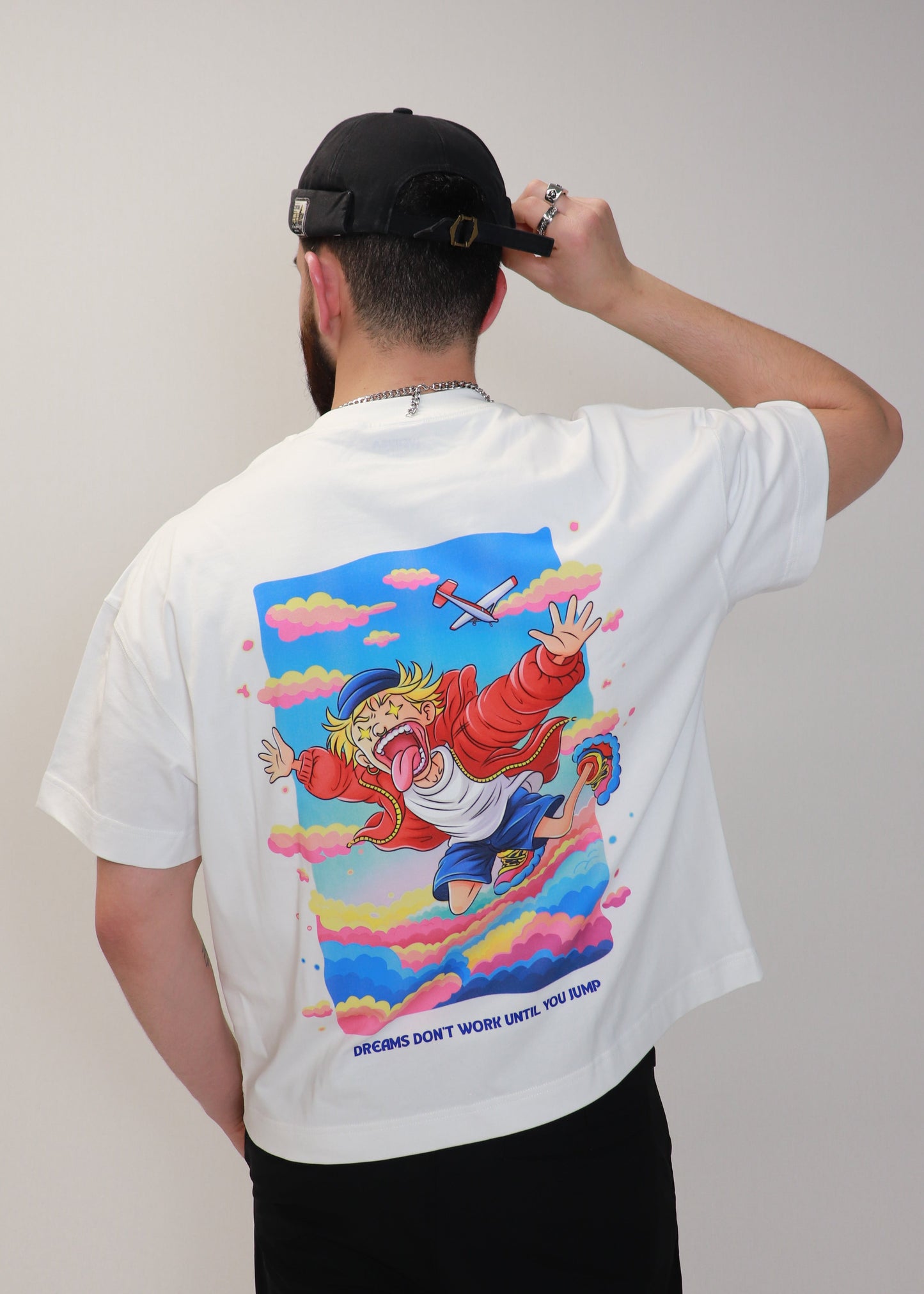 Rear view of white DMR oversized t-shirt with graphic artwork