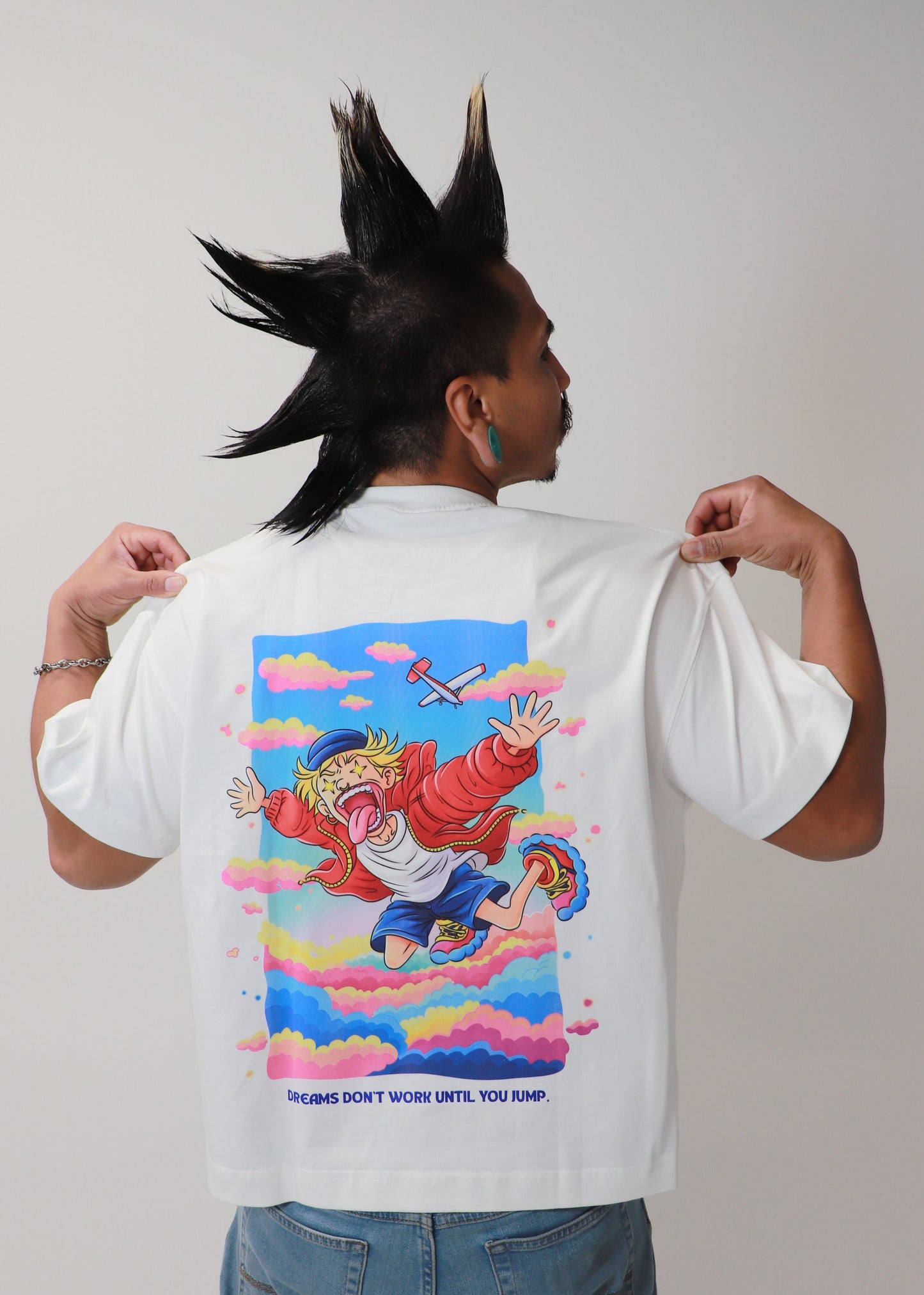 Male model showing back graphic of white DMR oversized t-shirt