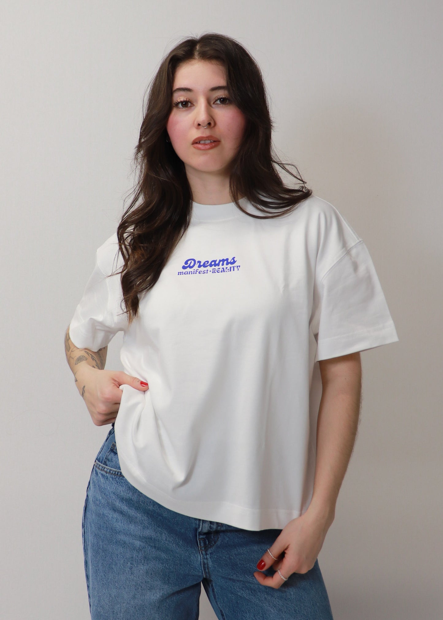 White oversized boxy DMR t-shirt front view worn by female model