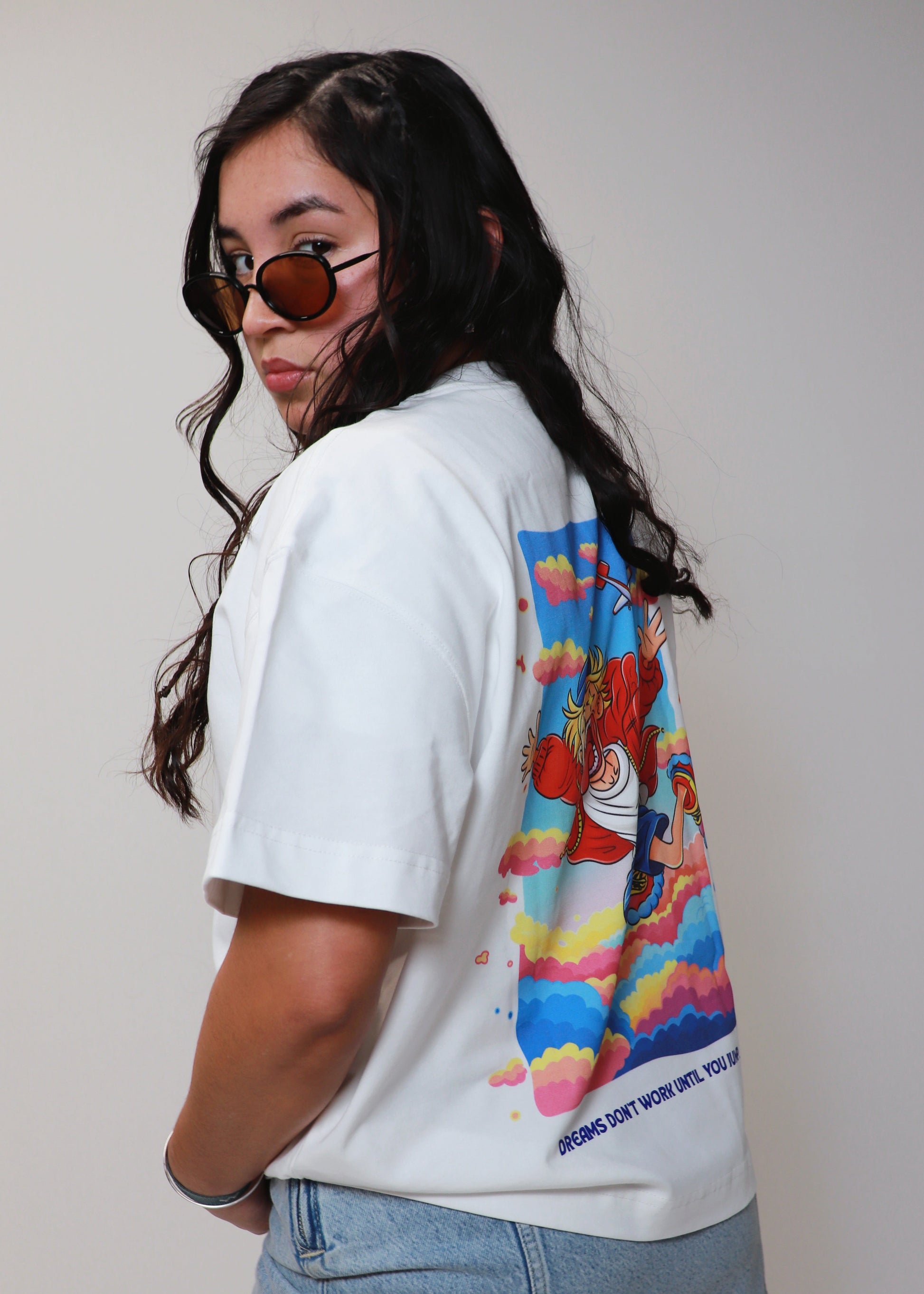 Side angle of white DMR oversized t-shirt showing back graphic